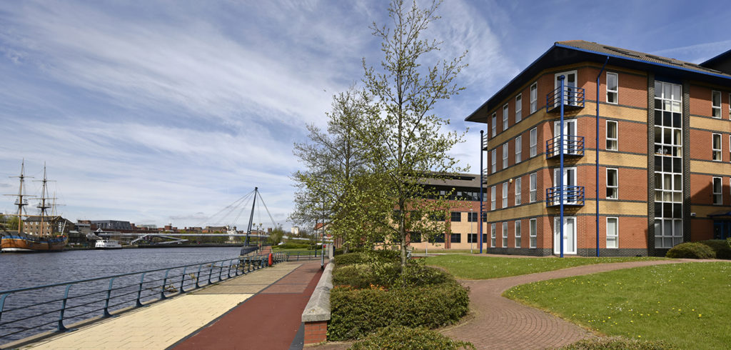 Co*Shabang Offices Stockton on Tees for co-working, co-sharing, hot desking, office & meeting room rentals.  Outside view of modern red brick building & River